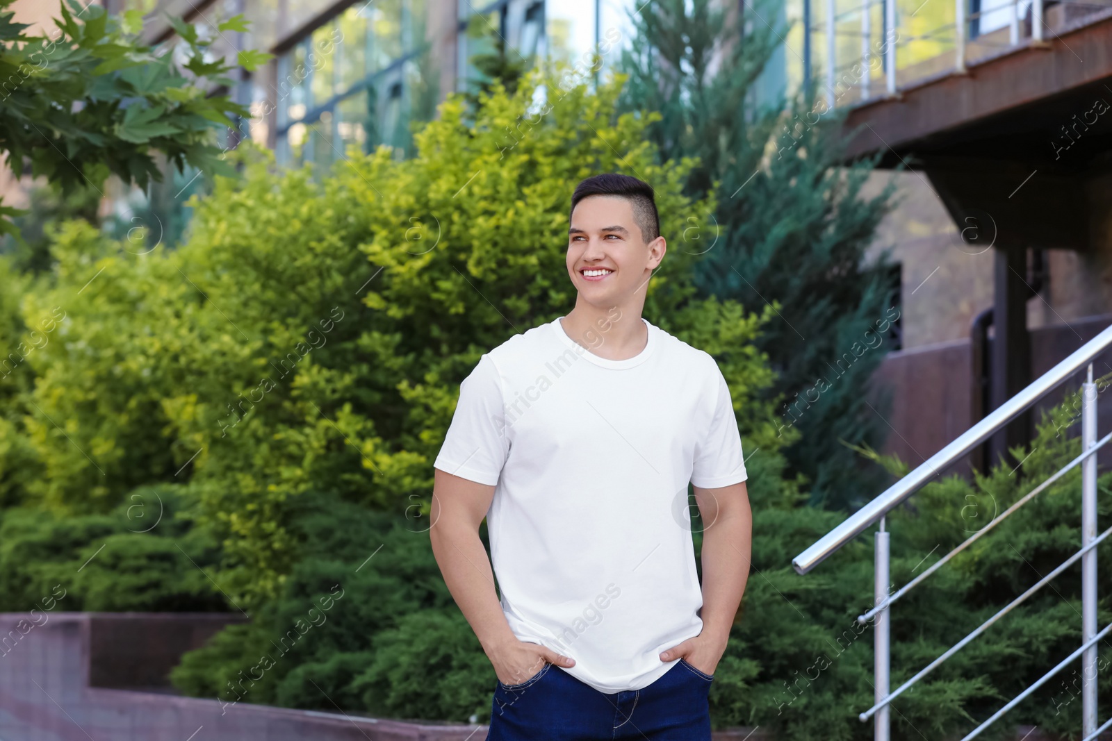 Photo of Young man in white t-shirt outdoors. Mockup for design