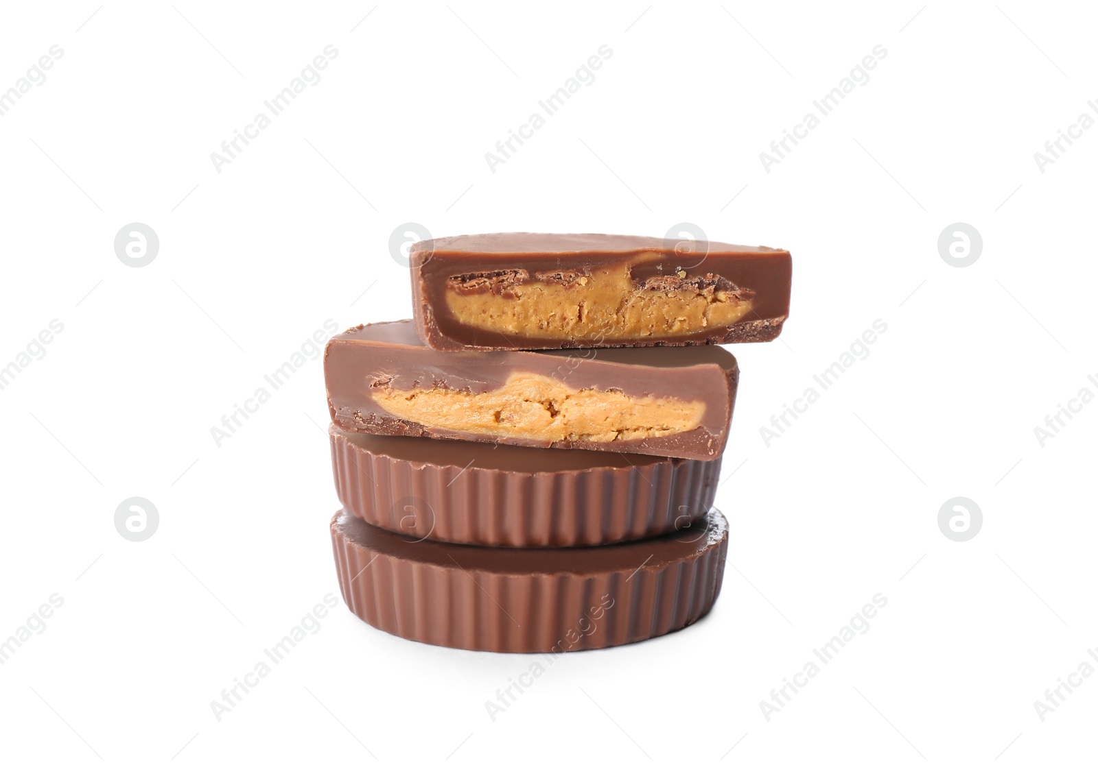 Photo of Cut and whole delicious peanut butter cups on white background