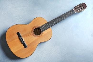 Photo of Beautiful classical guitar on color background, top view