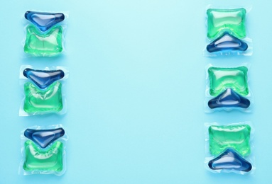 Laundry capsules on turquoise background, flat lay. Space for text