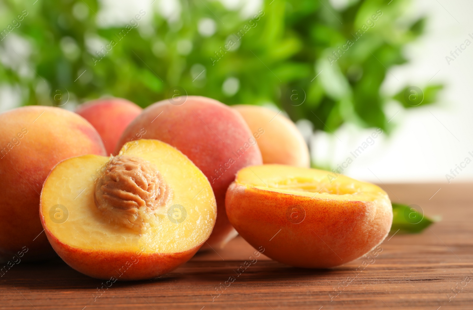 Photo of Fresh sweet peaches on wooden table, closeup