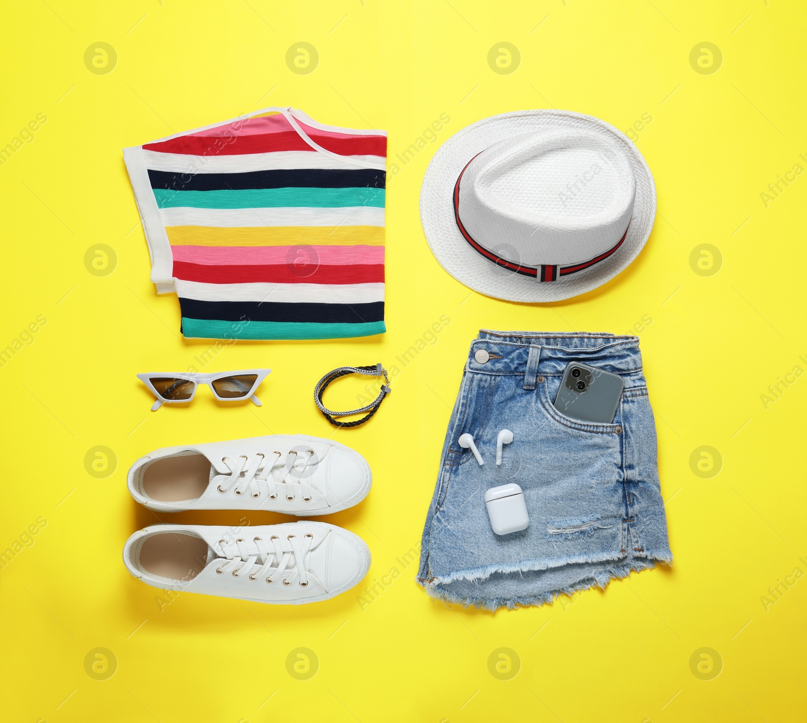 Photo of Flat lay composition with stylish clothes and accessories on yellow background