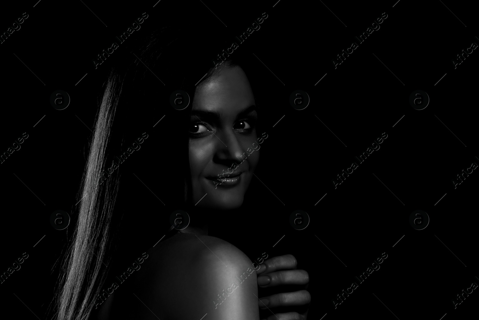 Image of Silhouette of woman in darkness. Portrait on black background