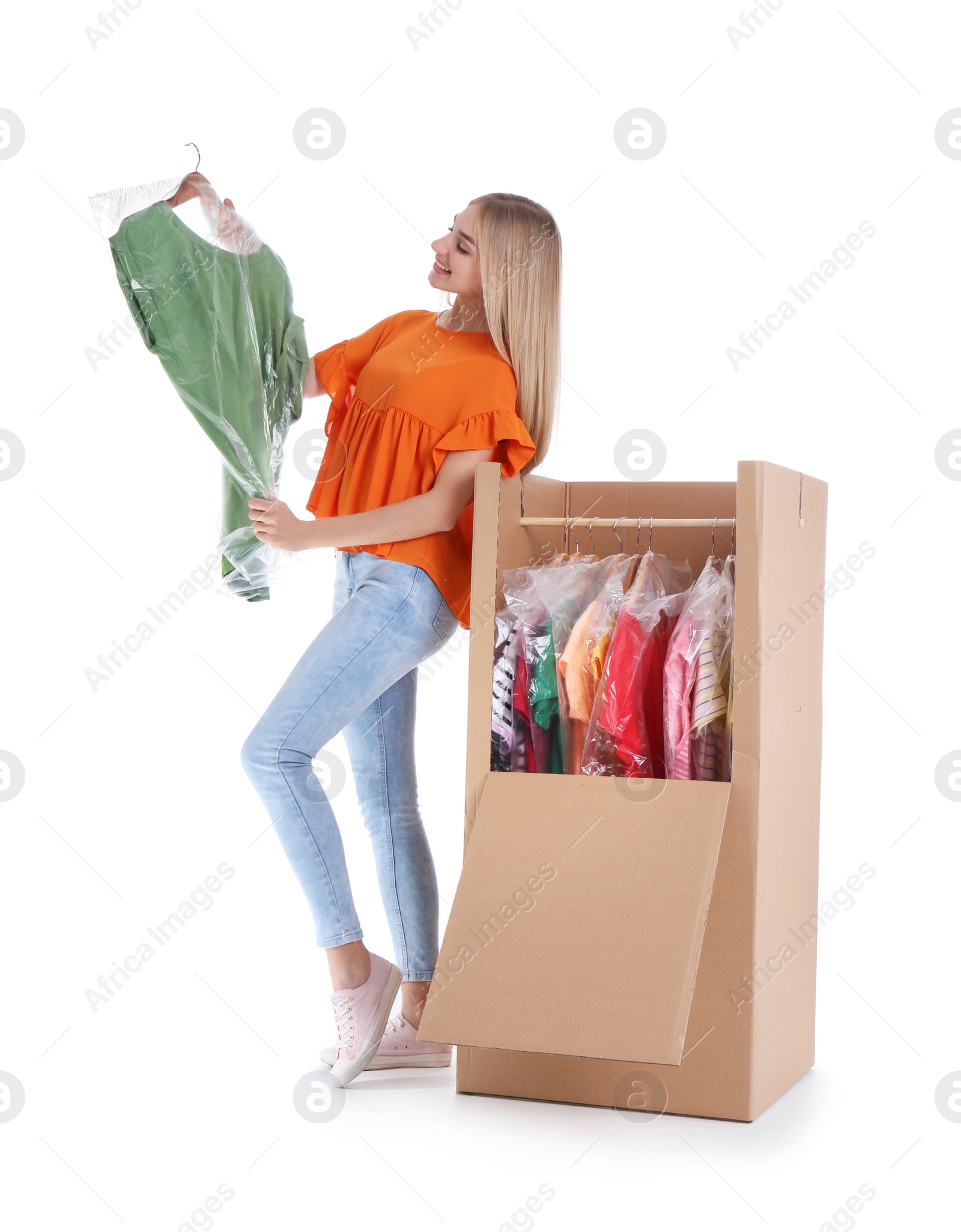 Photo of Young woman near wardrobe box on white background