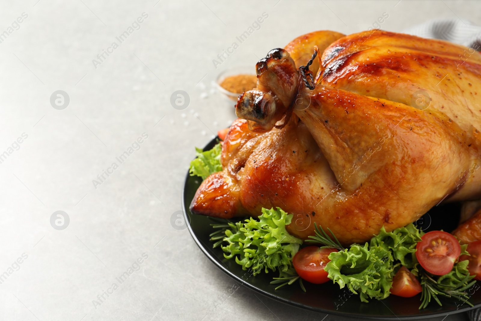 Photo of Platter of cooked turkey with garnish on table, closeup. Space for text