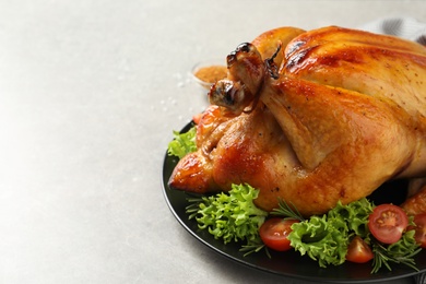 Photo of Platter of cooked turkey with garnish on table, closeup. Space for text