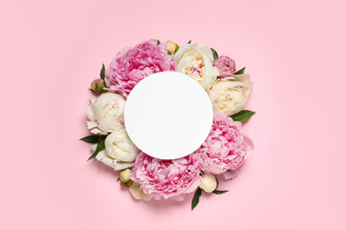 Photo of Beautiful peonies and blank card on pink background, flat lay. Space for text