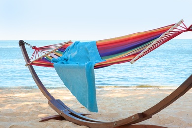 Photo of Colorful hammock with blanket at seaside. Summer vacation