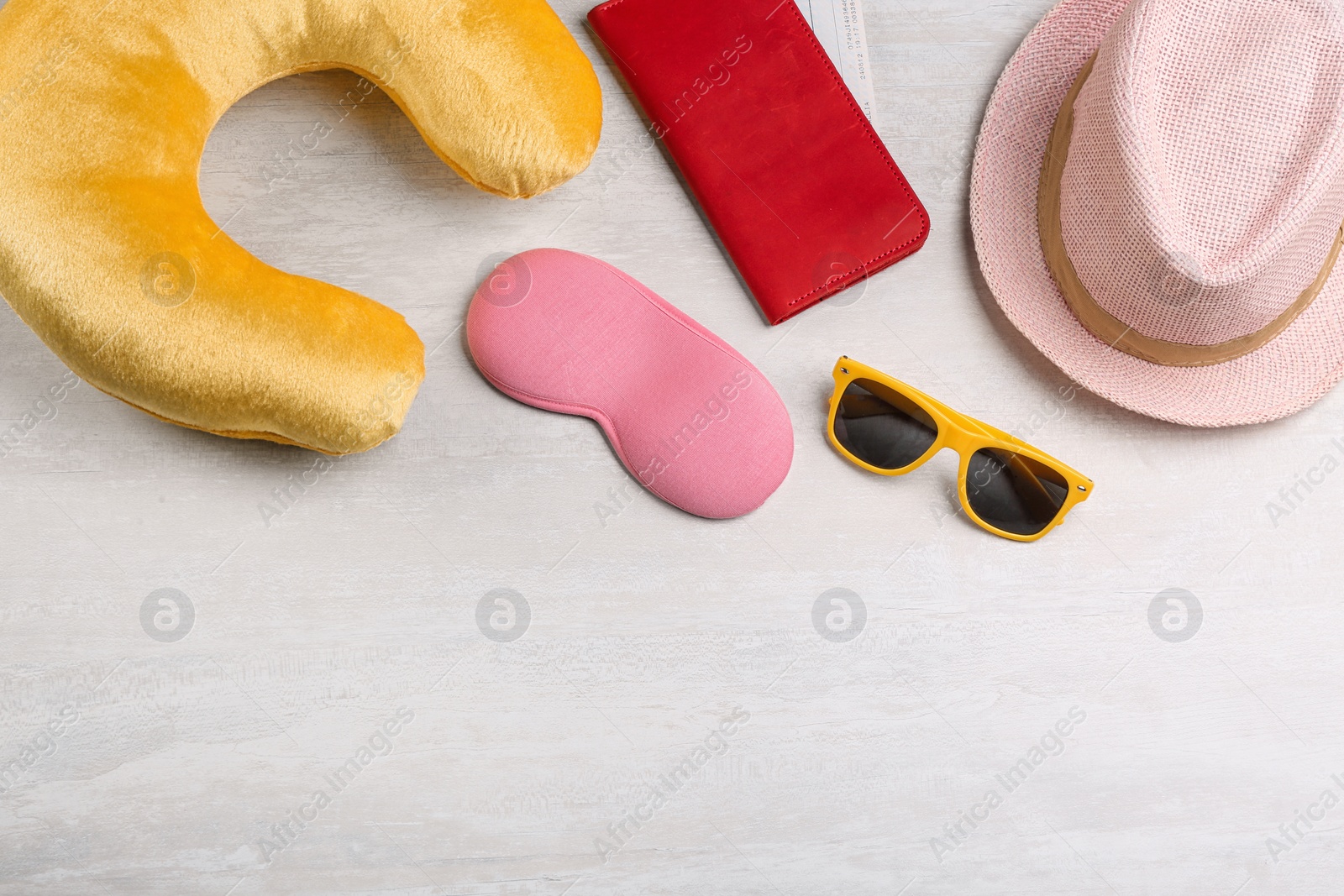 Image of Flat lay composition with yellow travel pillow on light background, space for text