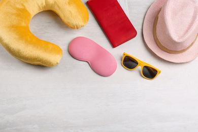 Flat lay composition with yellow travel pillow on light background, space for text