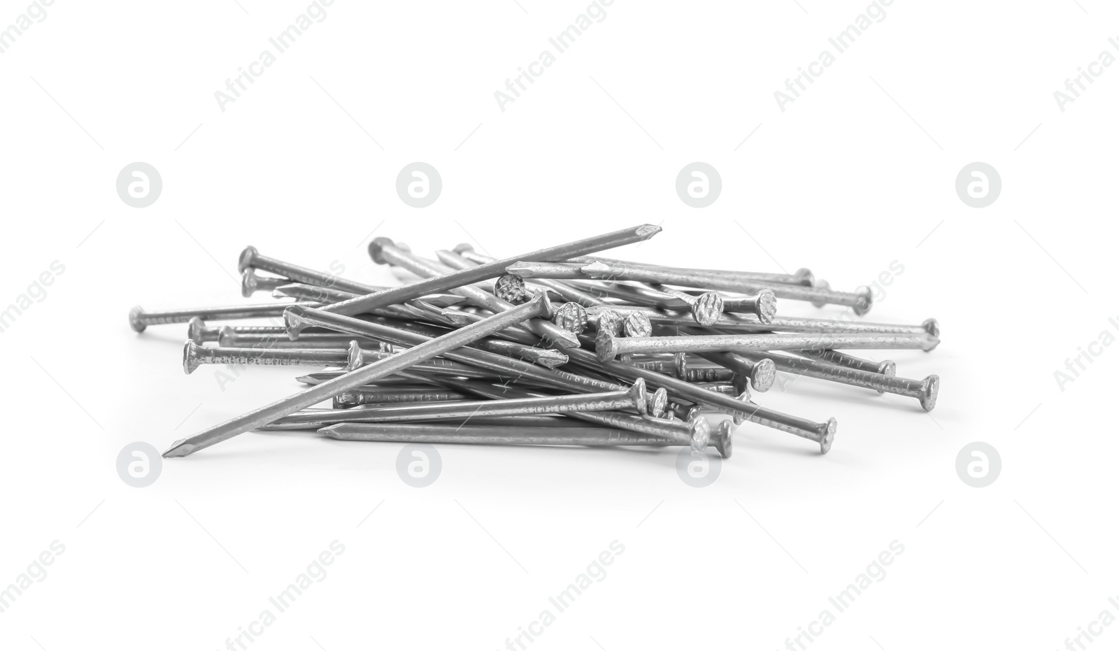 Photo of Pile of metal nails on white background