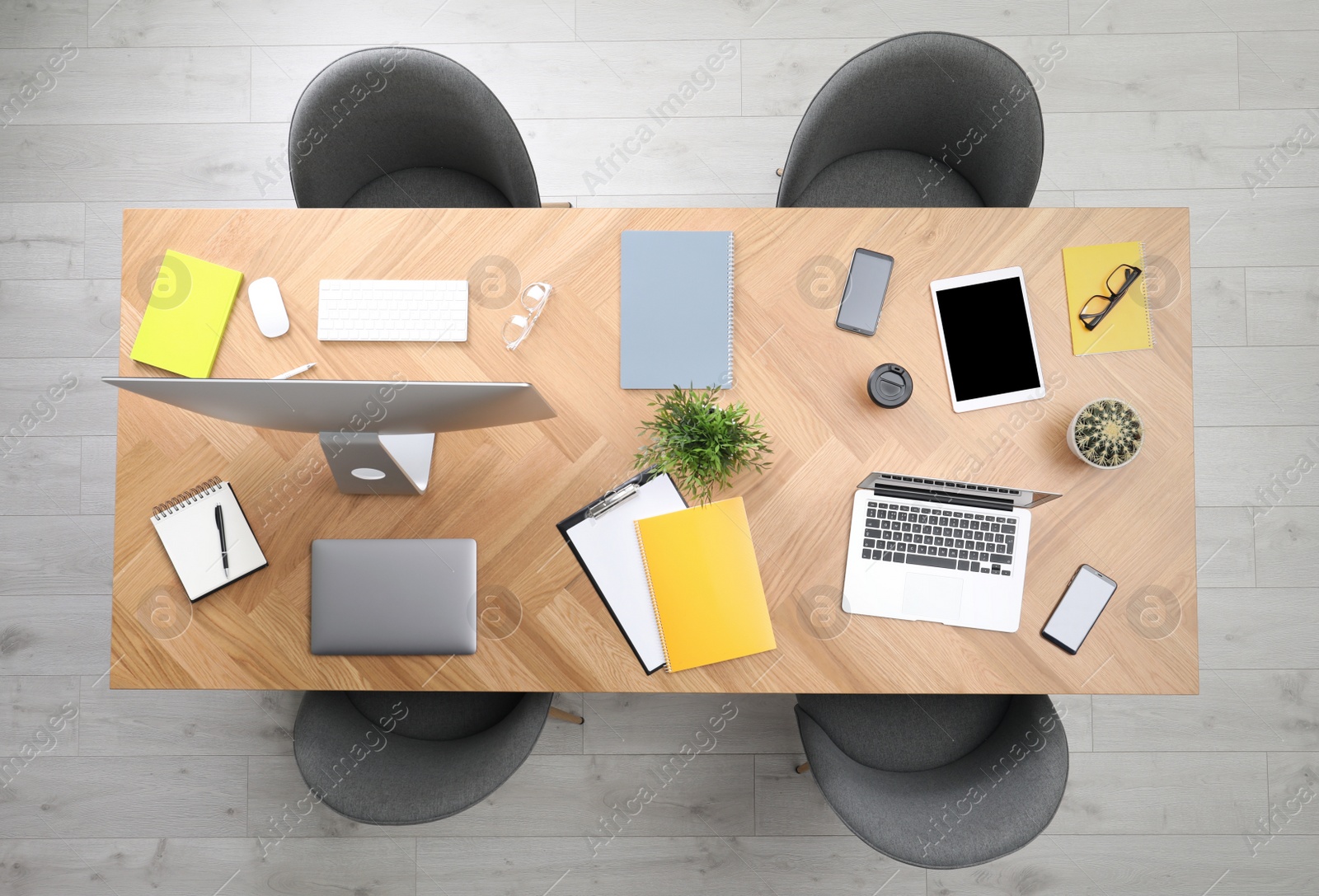 Photo of Modern office table with devices and chairs, top view