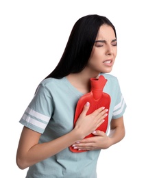 Woman using hot water bottle to relieve chest pain on white background