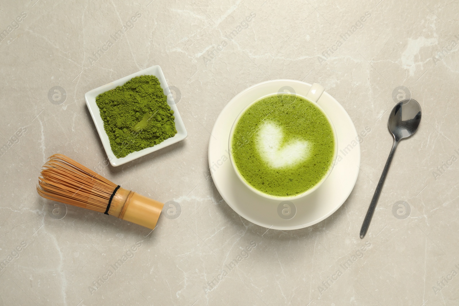 Photo of Flat lay composition with tasty matcha latte on light gray marble table