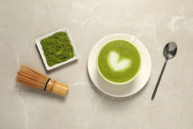 Photo of Flat lay composition with tasty matcha latte on light gray marble table