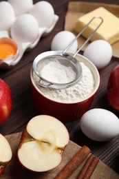 Photo of Traditional English apple pie ingredients on wooden table