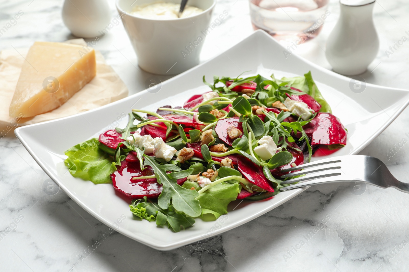 Photo of Plate with delicious beet salad served on table