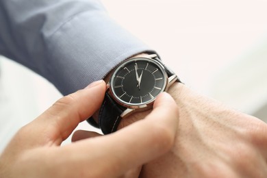 Photo of Man with luxury wrist watch on white background, closeup