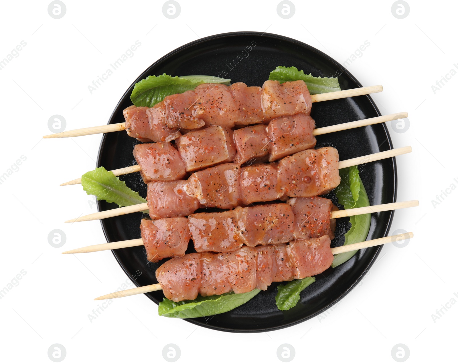 Photo of Wooden skewers with cut raw marinated meat isolated on white, top view