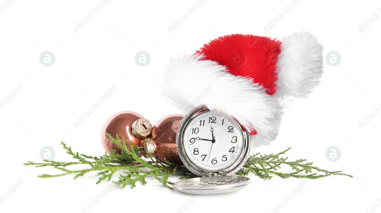 Photo of Pocket watch with Santa hat and festive decor on white background. New Year countdown