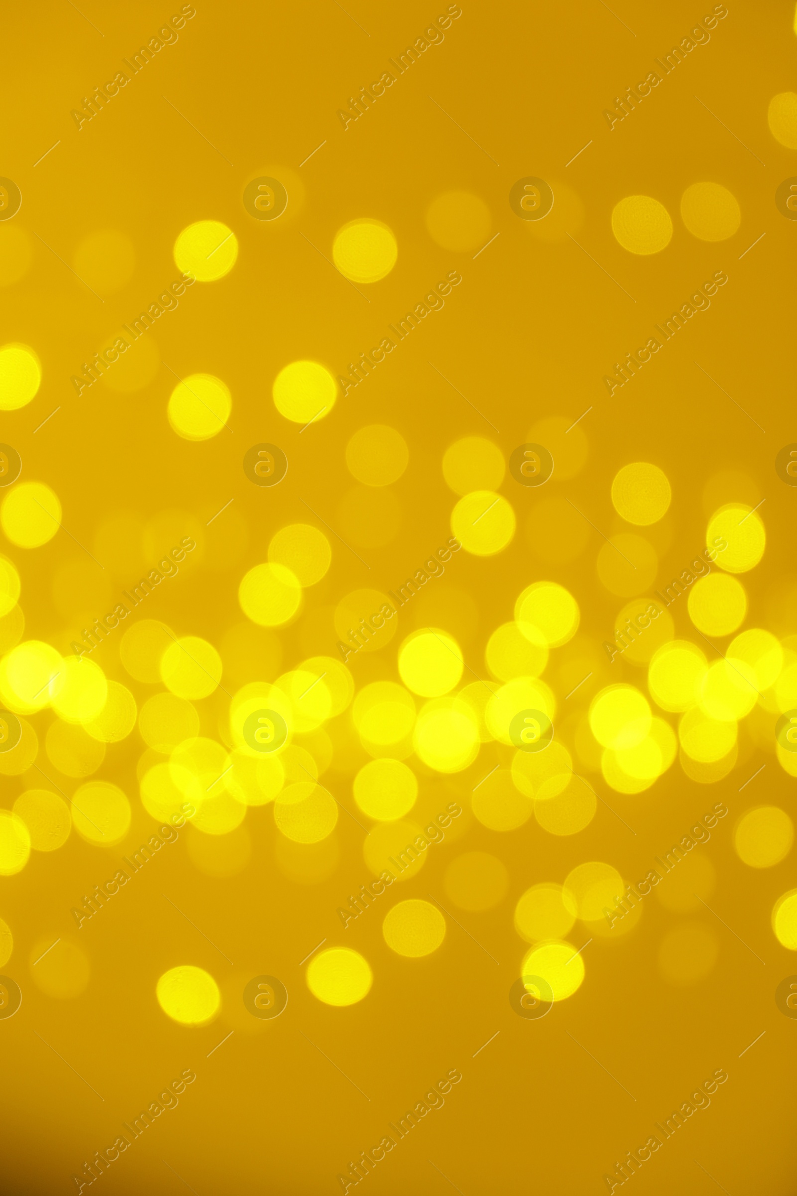 Photo of Blurred view of shiny gold lights. Bokeh effect