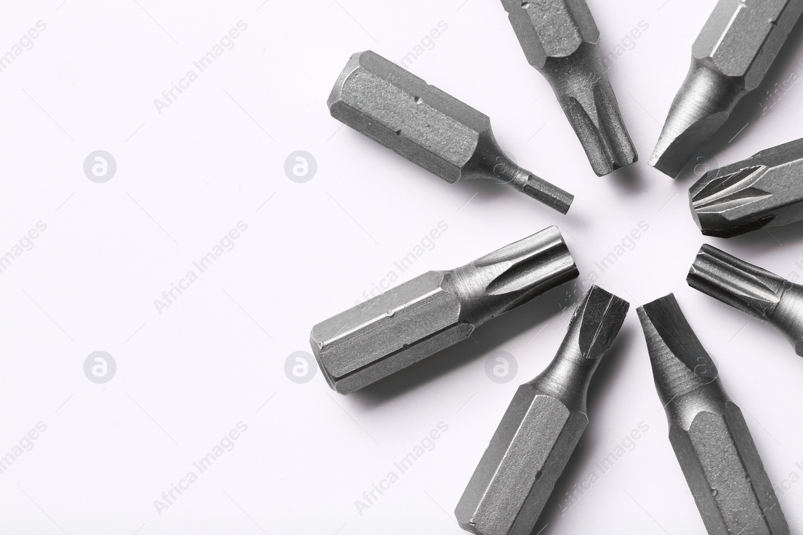 Photo of Different screwdriver bits on white background, top view