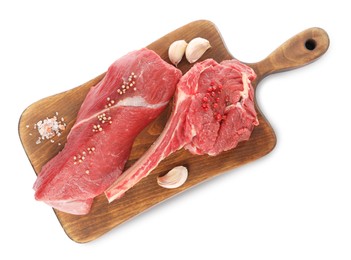 Photo of Board with pieces of raw beef meat and spices isolated on white, top view
