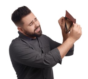 Upset man showing empty wallet on white background