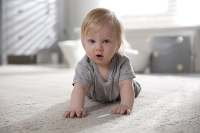Photo of Adorable little baby on floor at home