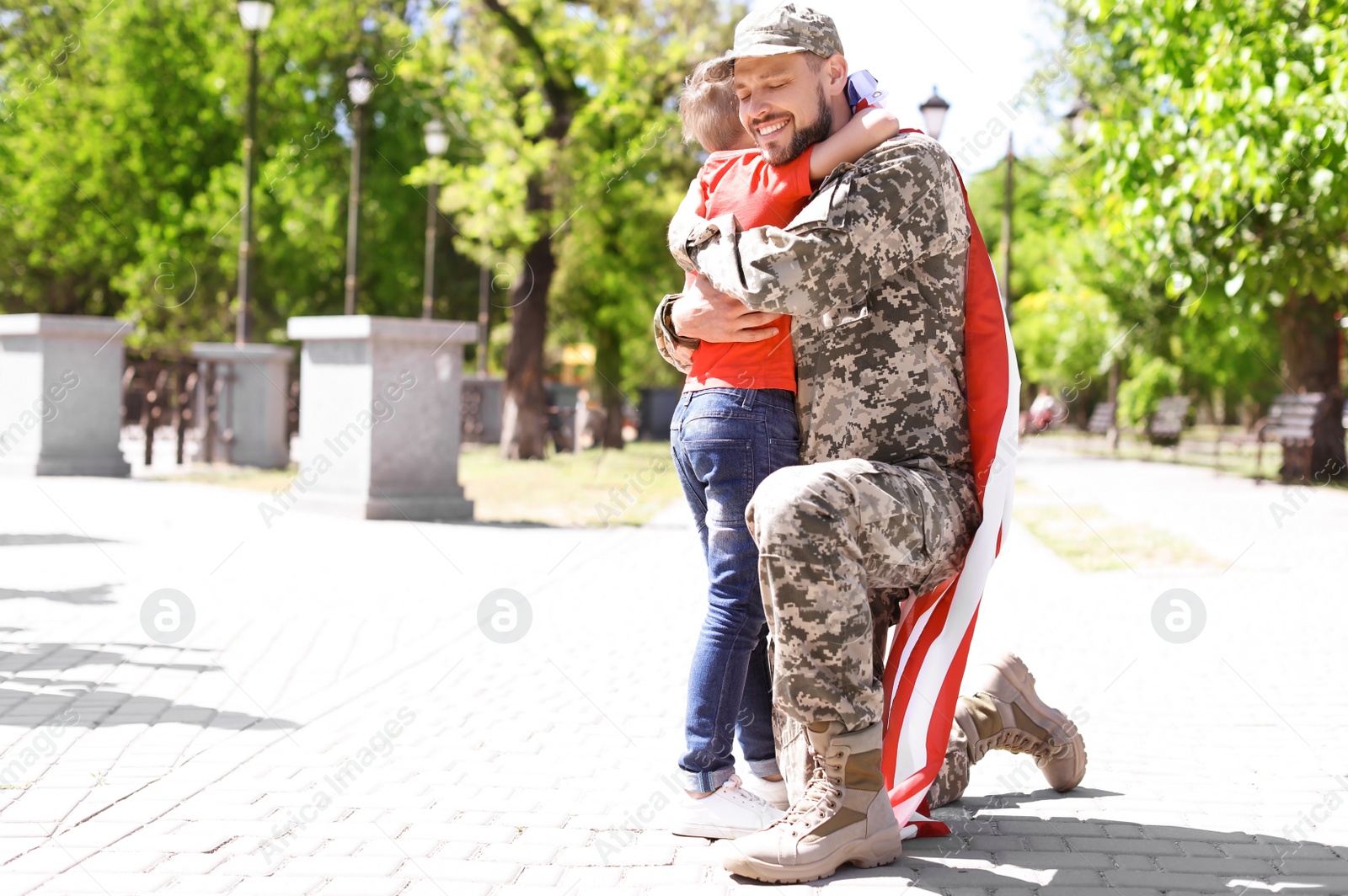 Photo of American soldier with his son outdoors. Military service