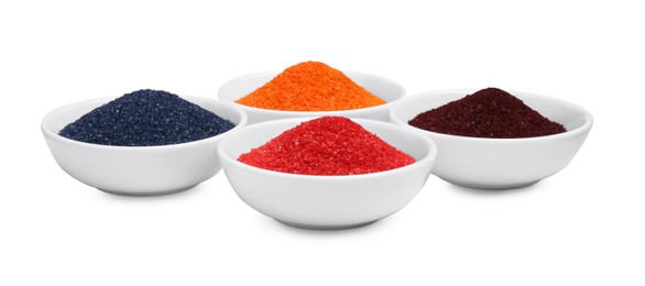 Photo of Bowls with food coloring on white background