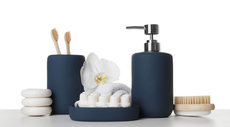 Bath accessories. Different personal care products and flower on table against white background