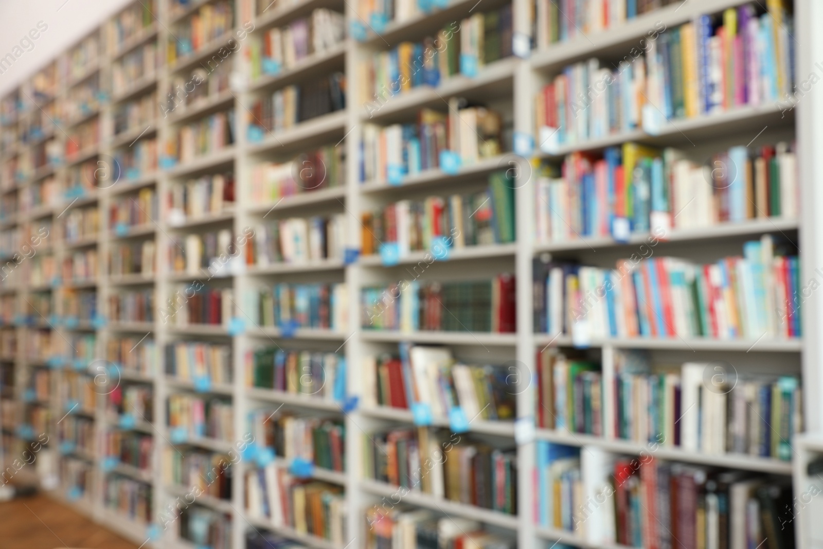 Photo of Blurred view of shelves with books in library