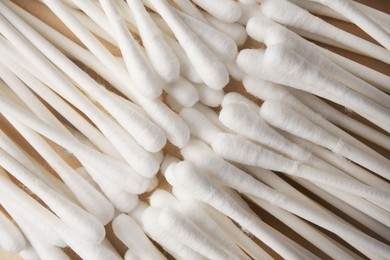 Photo of Many clean cotton buds on beige background, top view