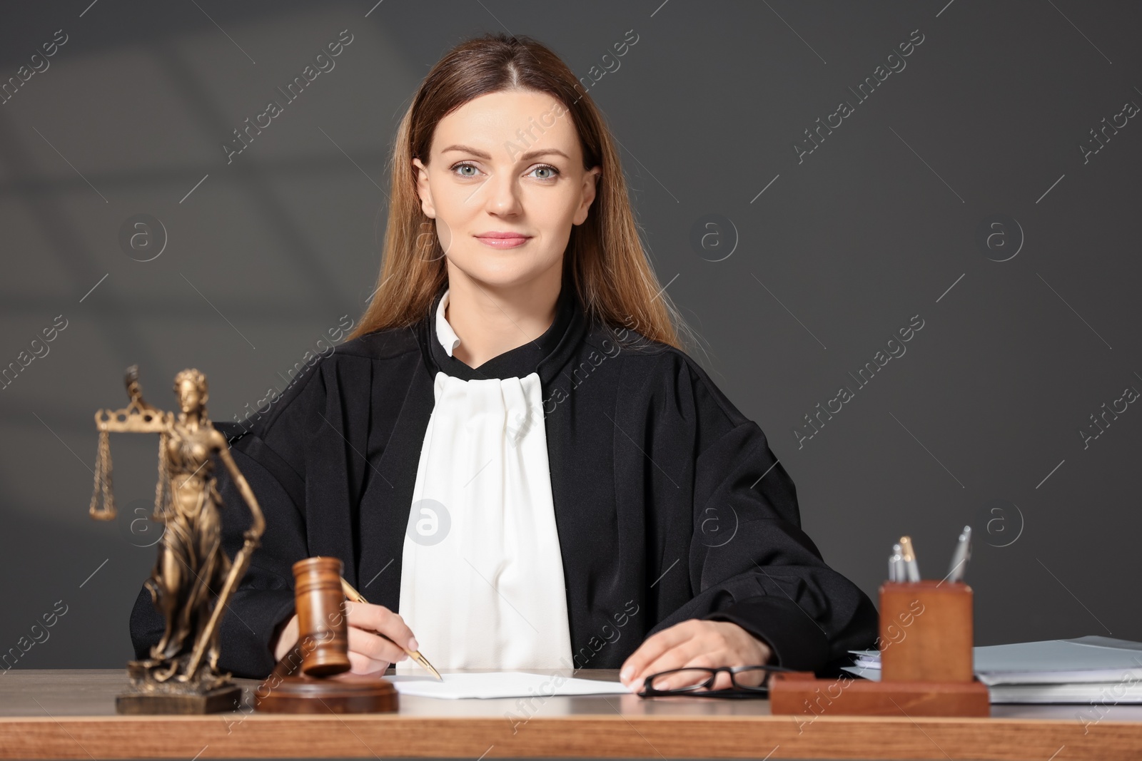 Photo of Judge working with document at table indoors