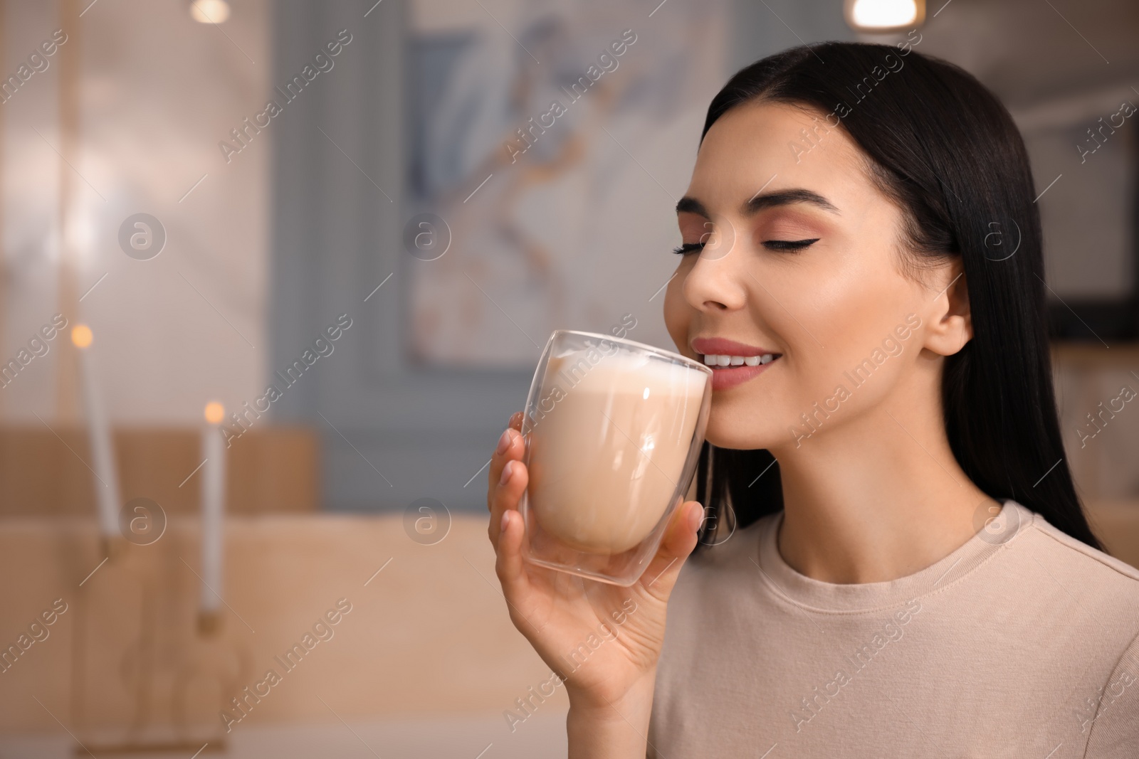 Photo of Woman enjoying delicious coffee at cafe in morning