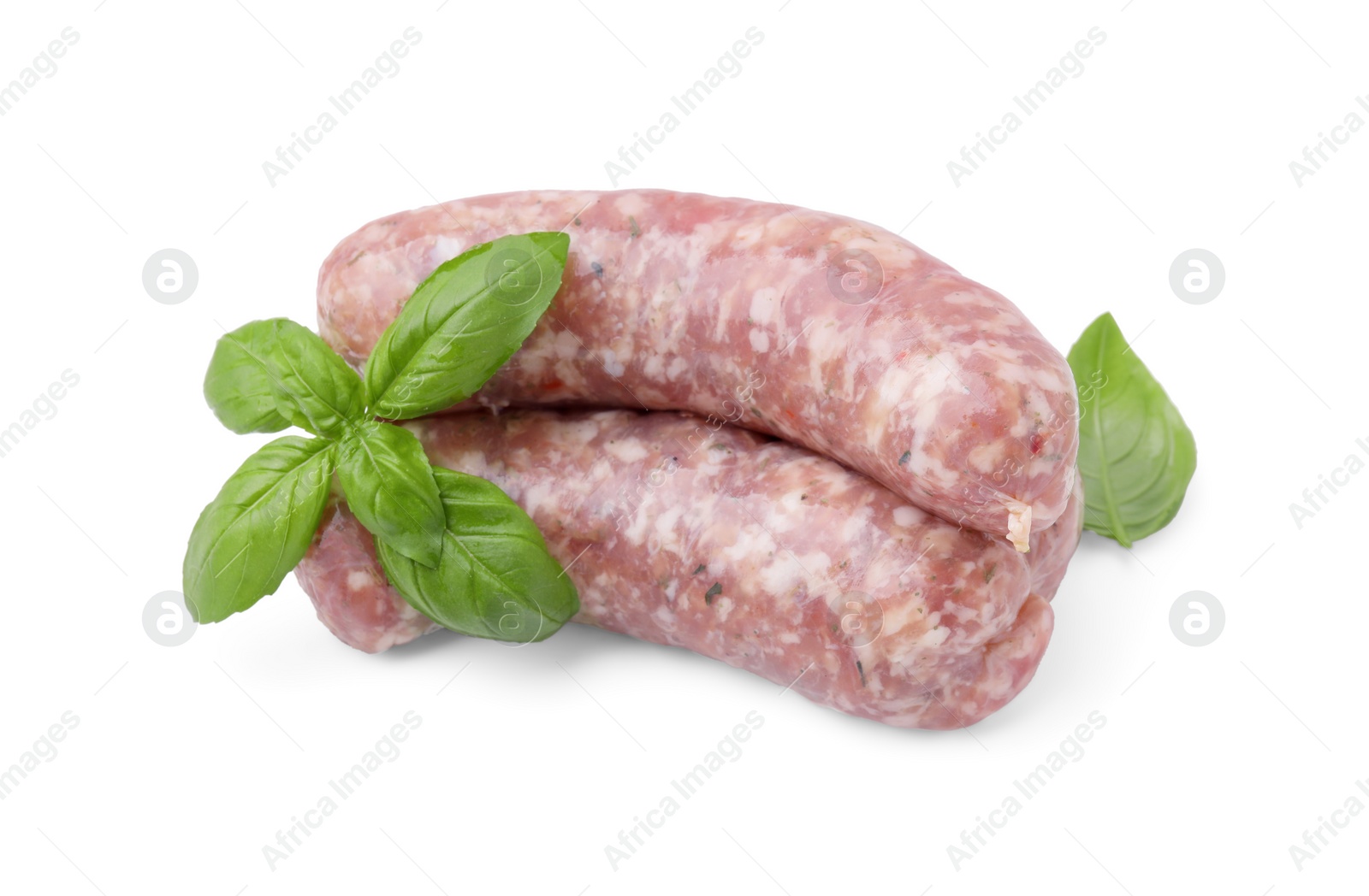 Photo of Raw homemade sausages and basil leaves isolated on white