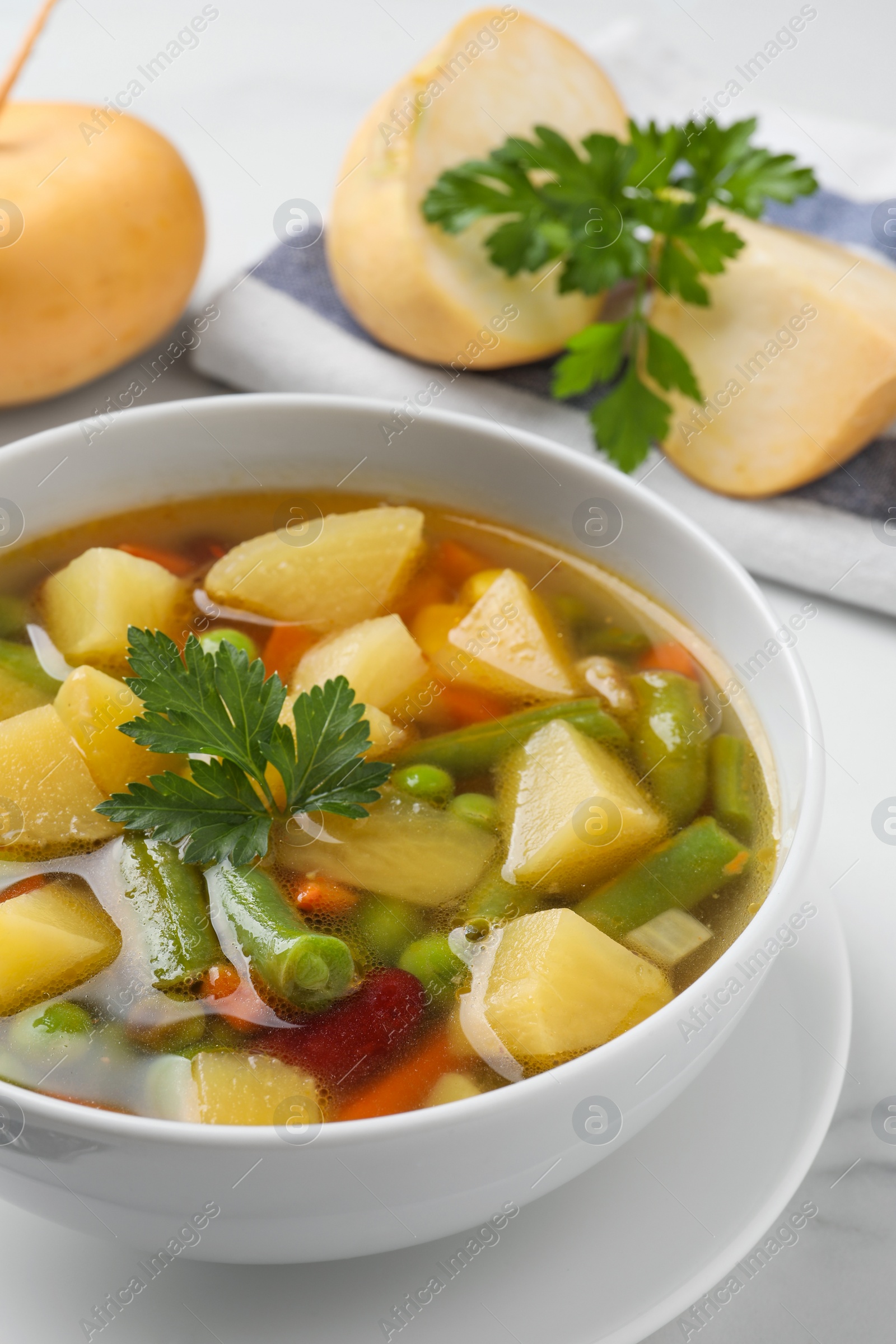 Photo of Bowl of delicious turnip soup on table, closeup