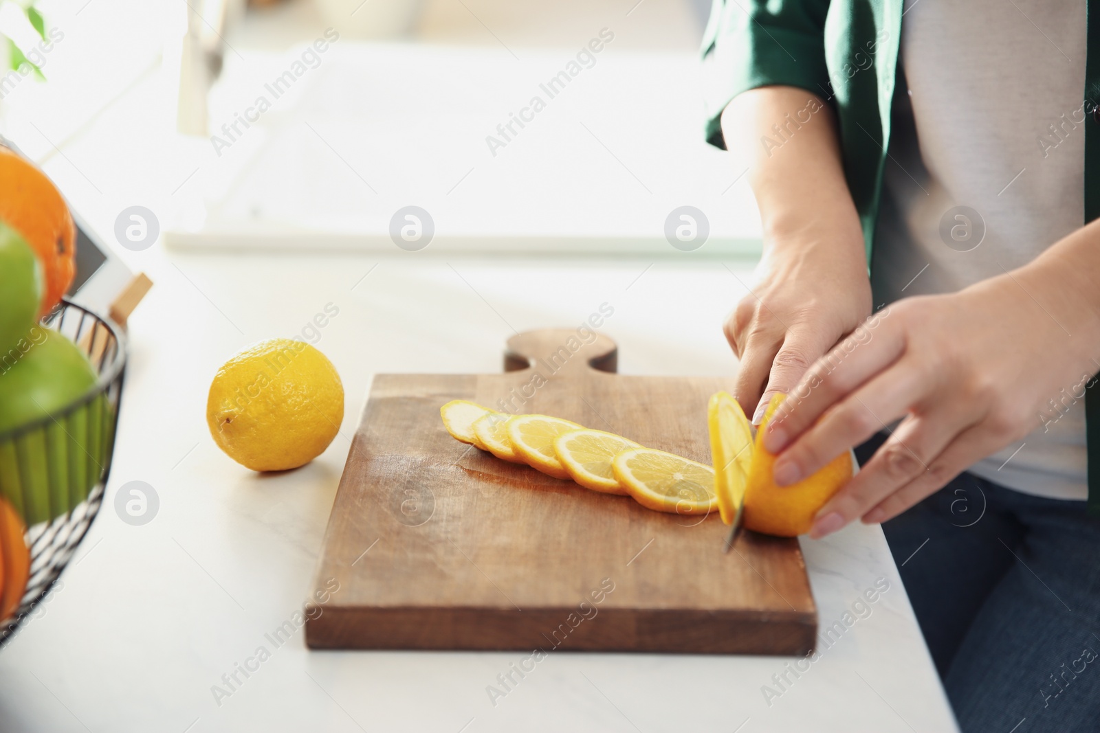 Photo of Woman cooking at table in kitchen, closeup