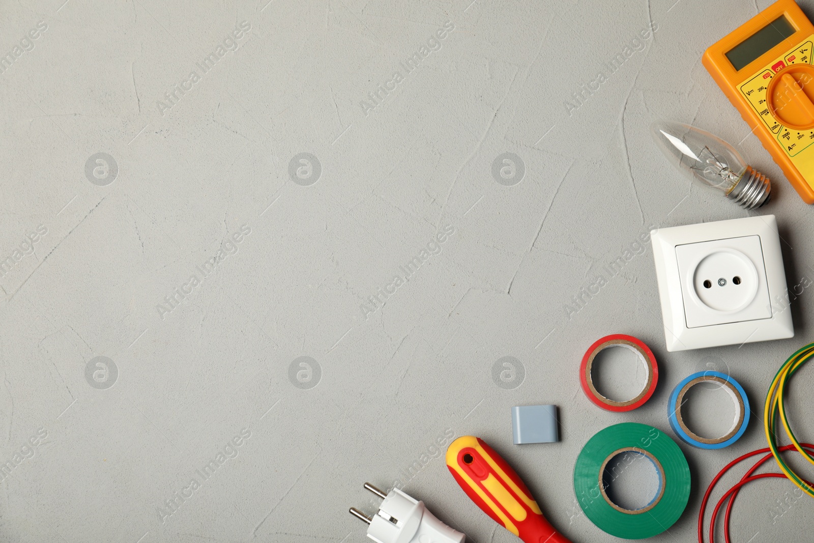 Photo of Flat lay composition with electrician's tools and space for text on gray background