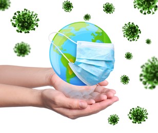 Woman holding Earth with medical mask on white background, closeup. Concept of coronavirus outbreak