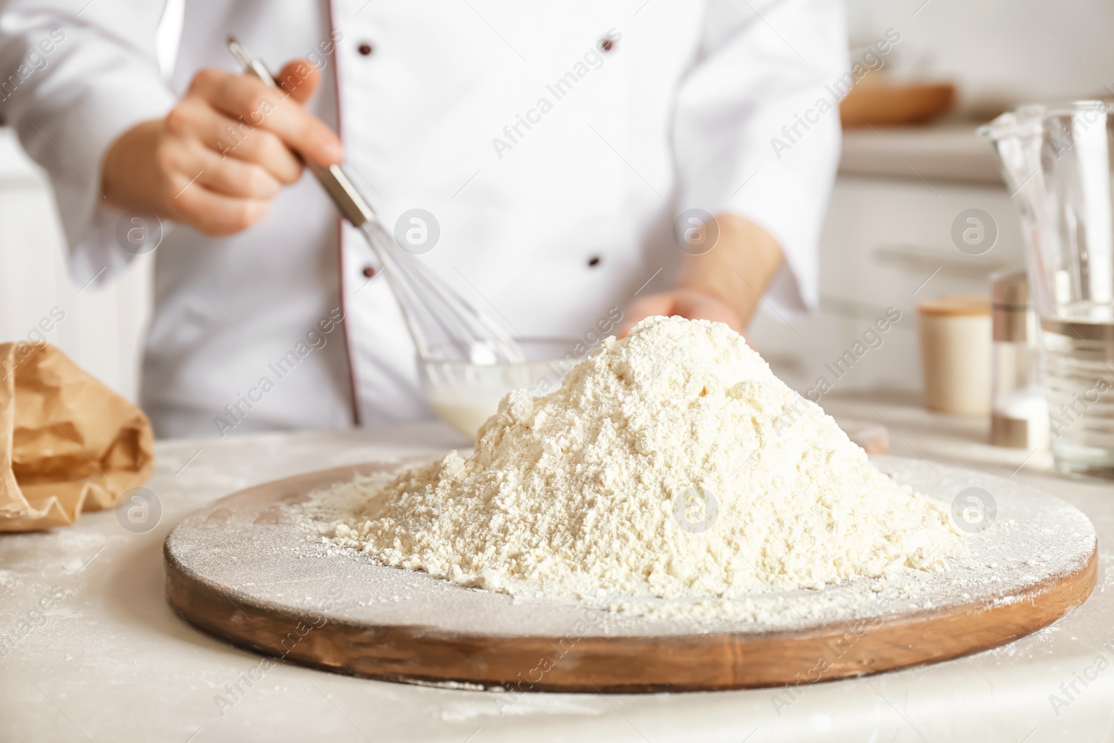 Photo of Pile of flour and chef on background