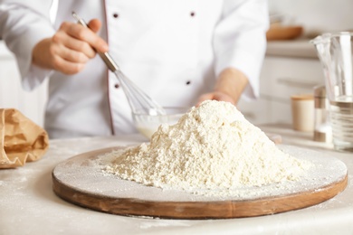 Photo of Pile of flour and chef on background