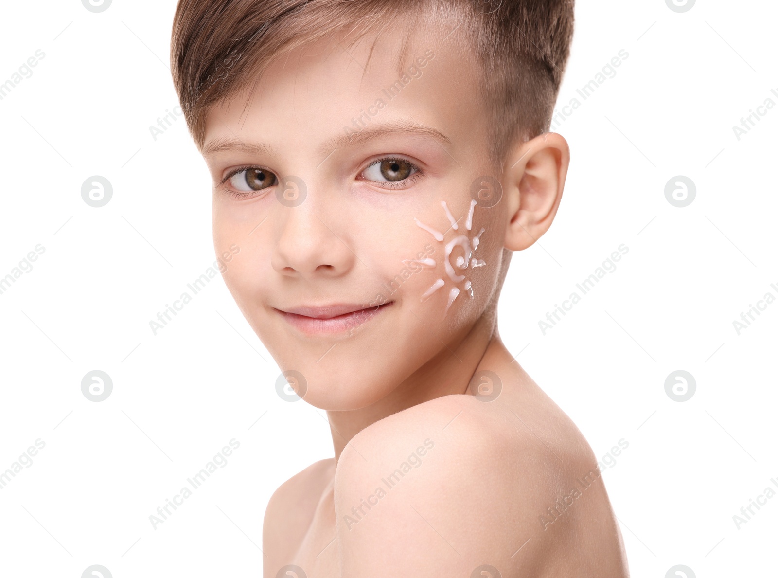Photo of Smiling boy with sun protection cream on his face against white background