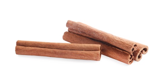 Photo of Pile of aromatic cinnamon sticks isolated on white