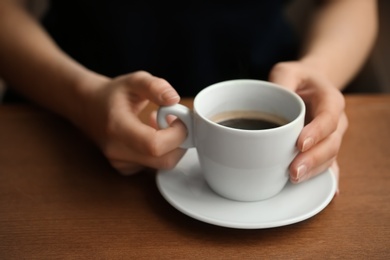 Photo of Woman with cup of aromatic coffee, closeup