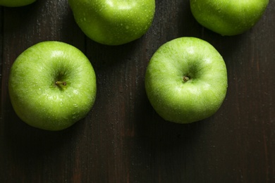 Fresh green apples on wooden background