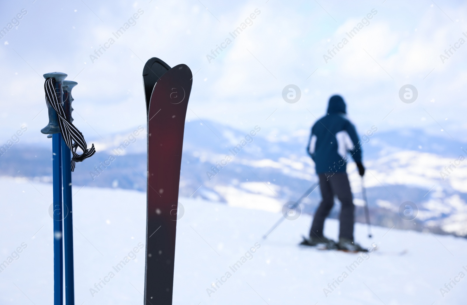 Photo of Ski and poles on beautiful snowy hill. Space for text