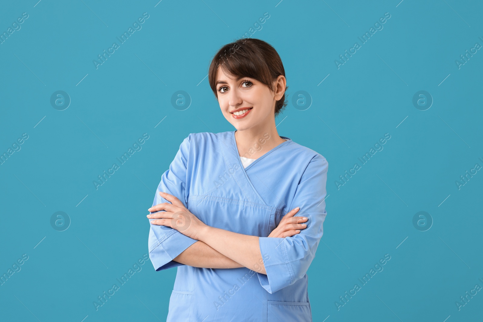 Photo of Portrait of smiling medical assistant on light blue background