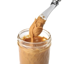 Photo of Jar and knife with creamy peanut butter on white background